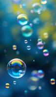 Floating iridescent soap bubbles with a blurred blue and yellow background photo