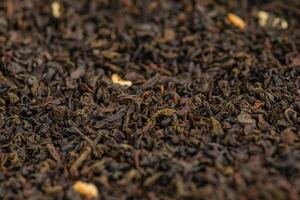 Black tea with bergamot macro photo as background. Thin focus line