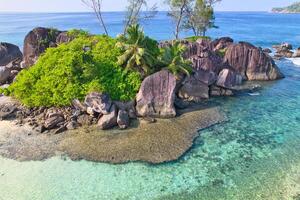 Drone shot of port glaud beach, Mahe, granite stones, white sandy beach and clear turquoise water, Seychelles 2 photo