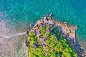 Drone shot of port glaud beach, small island nearby shot granite stones, white sandy beach and clear turquoise water, Mahe, Seychelles 5 photo