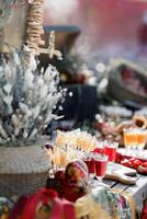 An old wooden cart, a small collection of simple treats bagels, lollipops, liqueurs photo