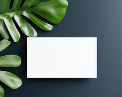White card on dark surface with green leaves creates fresh look photo