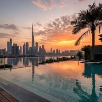 Dubai Skyline from Infinity Pool at Sunset Reflecting Sky and Palm Trees photo