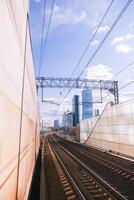 A train is on the tracks in front of a building photo