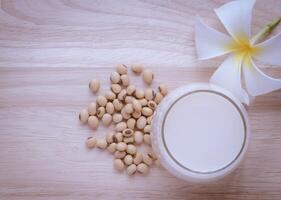 Fresh Soy milk or Soya milk in a glass and soybean seeds photo