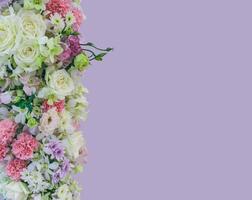 Beautiful bouquet flowers with different types of colorful flowers on violet color background photo