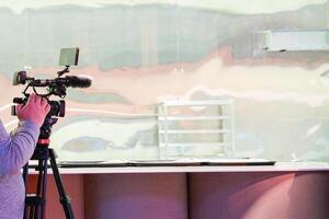 A man is filming a scene with a camera and microphone photo