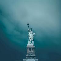 The statue of liberty is standing in front of a cloudy sky photo