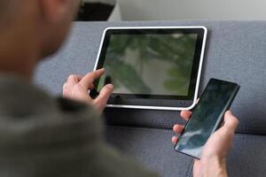 Digital tablet computer with isolated screen in male hands over cafe background photo
