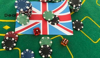 Dice with poker chips and playing card on background of dollar bills. flag of Great Britain photo