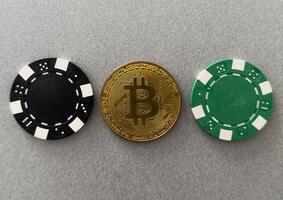 Bitcoin gold coin on the poker table with chips photo