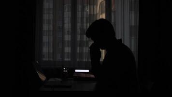 silhouette of a man in the office at his desk suffering from a runny nose video