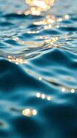 Abstract sun glare bokeh effect on rippling blue water photo