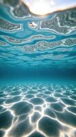 Distorted sky view underwater above sunlit sandy bottom photo