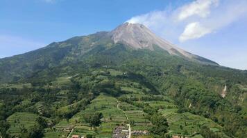 Aerial view of Mount Merapi and lush green farmlands in Central Java, Indonesia video