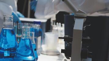 A laboratory with blue liquid and a person in a lab coat video