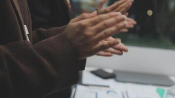 People clapping in front of a computer screen video
