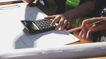 A person is using a calculator to work on a project video