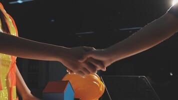 Two people shaking hands with a house and a car video