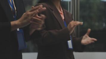 Two people clapping in front of a window video