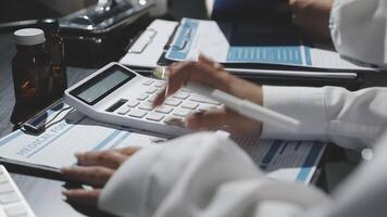 A person is using a calculator to calculate the cost of a prescription video