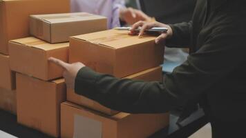 A person is holding a pen and pointing at a stack of boxes video