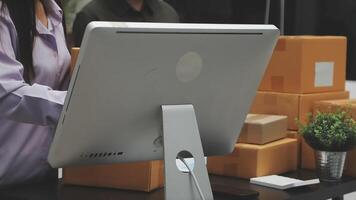 A woman is using a computer to check out a package video