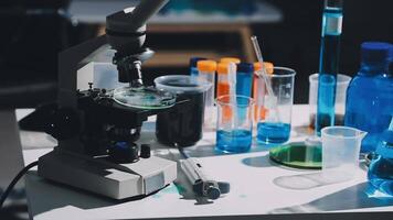 A microscope and other laboratory supplies on a table video