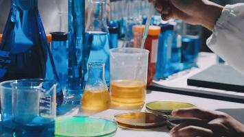 A person is working in a laboratory with many different colored liquids video