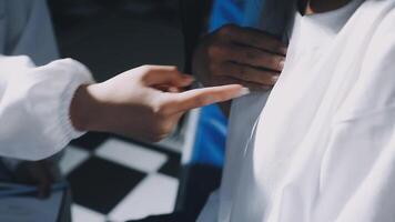 A person in a white shirt is pointing to another person video