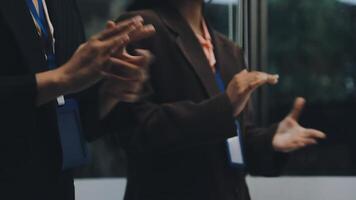 Two people standing in front of a window with their hands up video