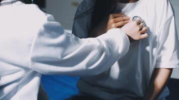 A woman is putting a pacemaker on a person video