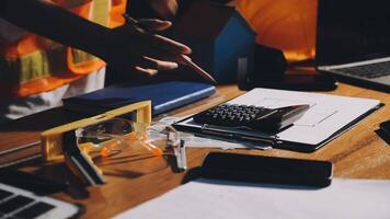 A person working on a desk with a calculator, paper and other items video