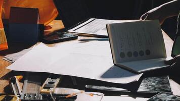 A person is holding a notebook and a laptop on a table video
