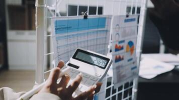 A person holding a calculator in front of a white board video