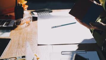 A person is holding a notebook and a pen on a desk video