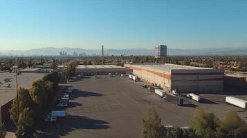 Aerial view of an industrial area with trucks and a city skyline in the background photo