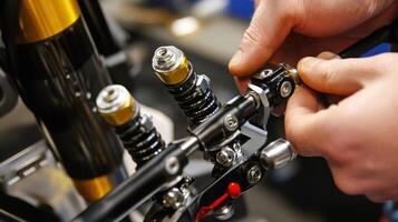 A person adjusts components of a suspension system in a mechanical setting photo