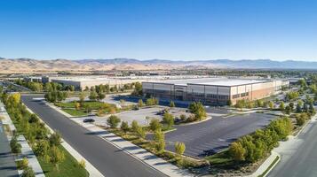 Aerial view of a large industrial complex surrounded by greenery and mountains photo
