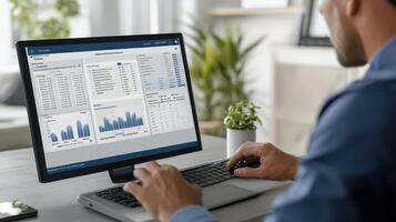 A person analyzing data on a computer screen with graphs and tables in a modern workspace photo
