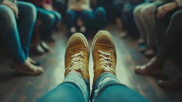 A close-up of yellow sneakers in a circle of people, suggesting a social gathering photo