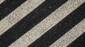 Close-up of a textured surface with diagonal black and white stripes photo