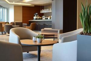 Modern lounge area with comfortable seating and a bar in the background photo