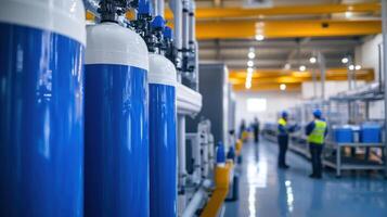 Industrial facility with blue tanks and workers engaged in operations photo