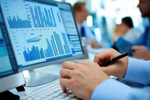 A person analyzes data on a computer screen, displaying graphs and statistics photo