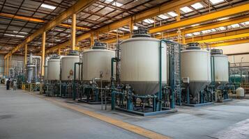 Industrial facility with large storage tanks and piping for processing materials photo