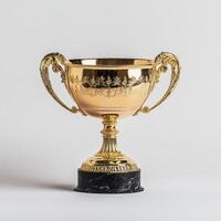 A shiny gold trophy with intricate designs and handles, resting on a black marble base. photo