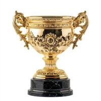 A decorative golden trophy with ornate designs atop a black marble base. photo