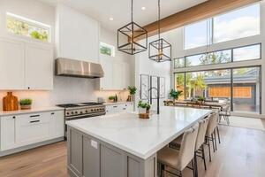 Modern kitchen with large island, natural light, and stylish decor. photo