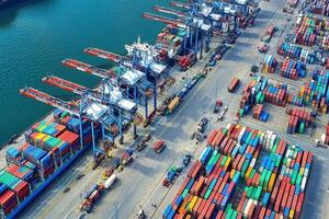 Aerial view of a busy shipping port with containers and cranes for cargo handling. photo